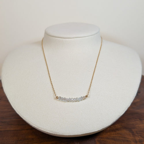 April white topaz birthstone necklace on a jewelry display bust