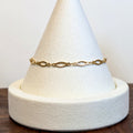 Golden Links bracelet with slender open marquise links, shown on a display cone