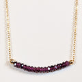 January birthstone necklace with faceted garnet beads on a gold chain