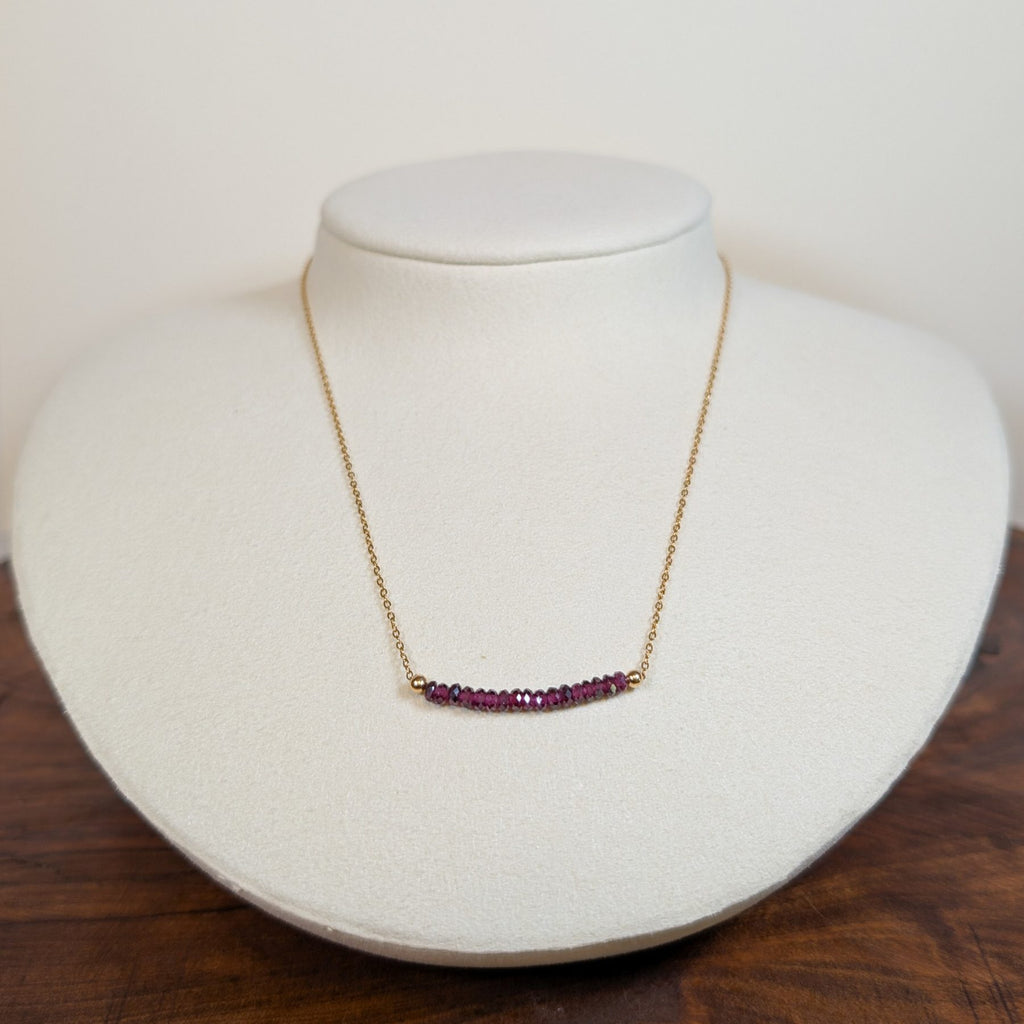 January garnet birthstone necklace on a jewelry display bust