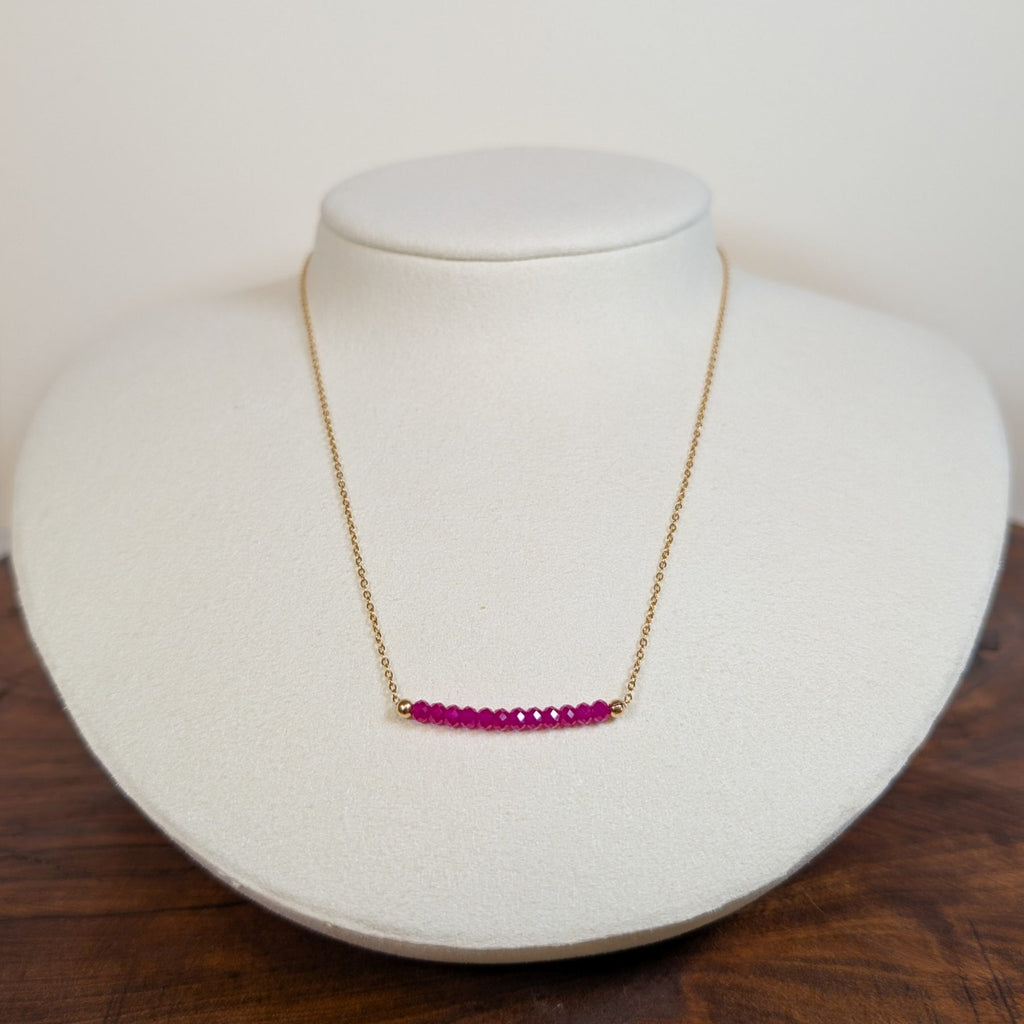 July ruby birthstone necklace on a jewelry display bust