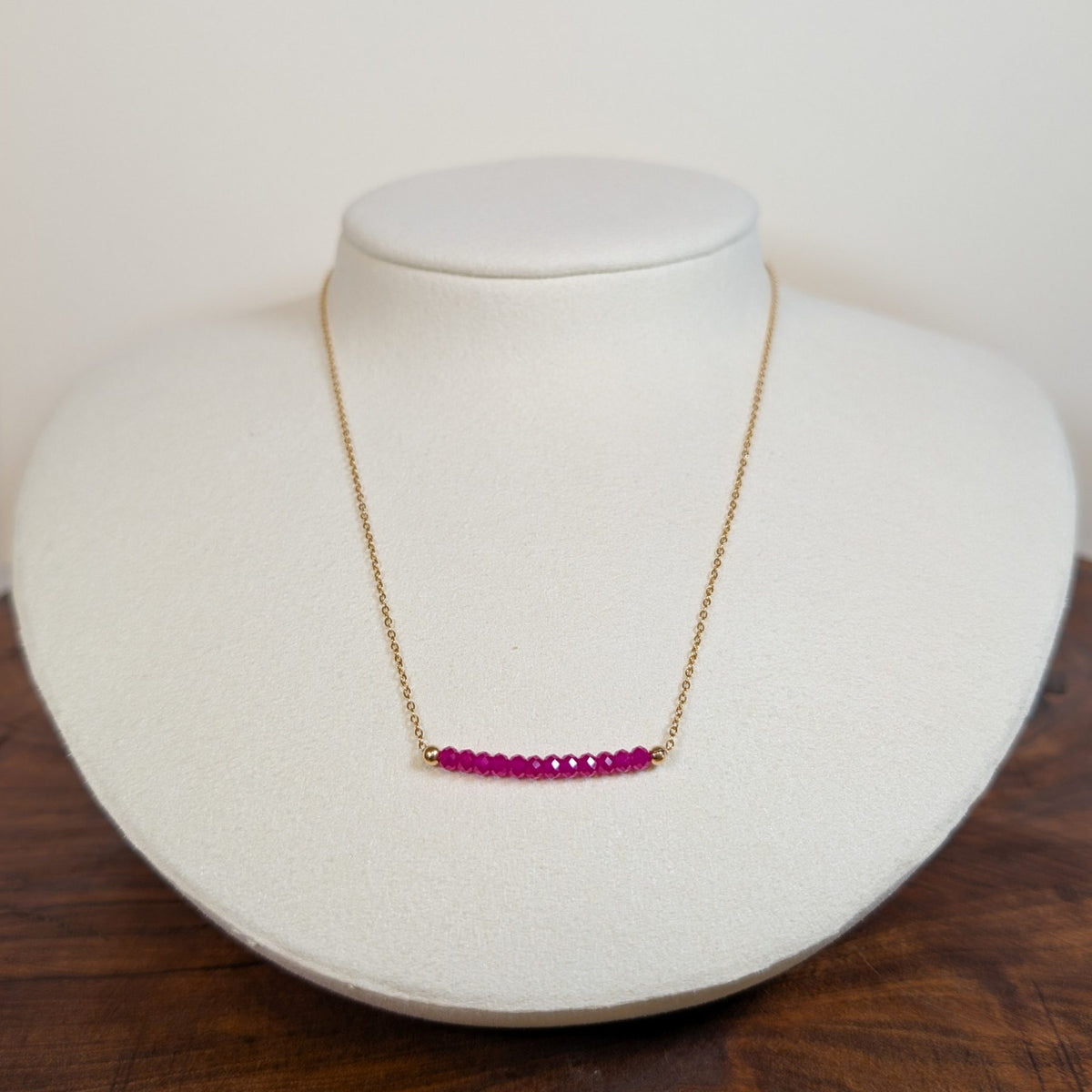 July ruby birthstone necklace on a jewelry display bust