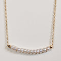 June birthstone necklace with freshwater pearl beads on a gold chain