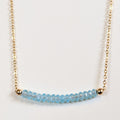 March birthstone necklace with faceted aquamarine beads on a gold chain