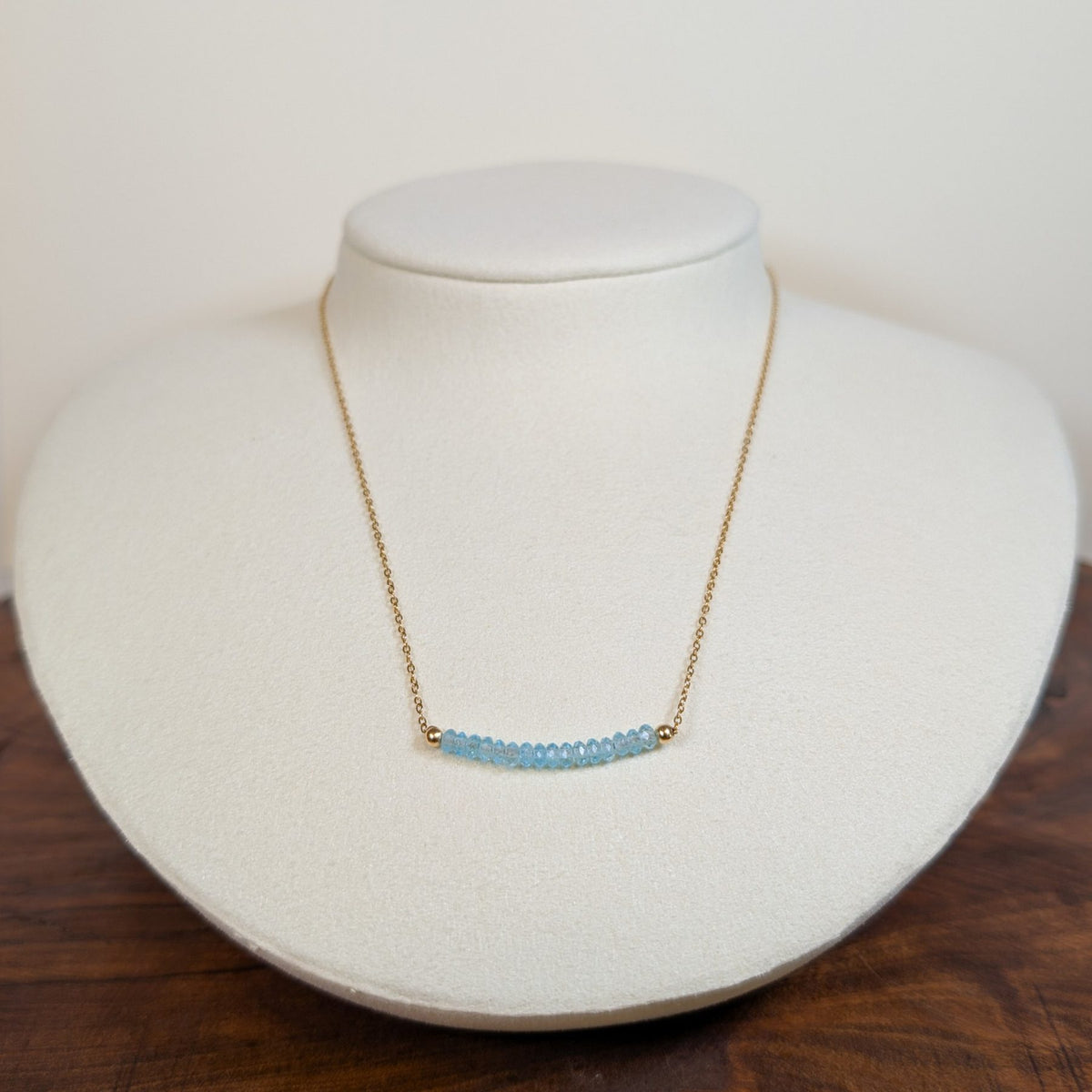 March aquamarine birthstone necklace on a jewelry display bust