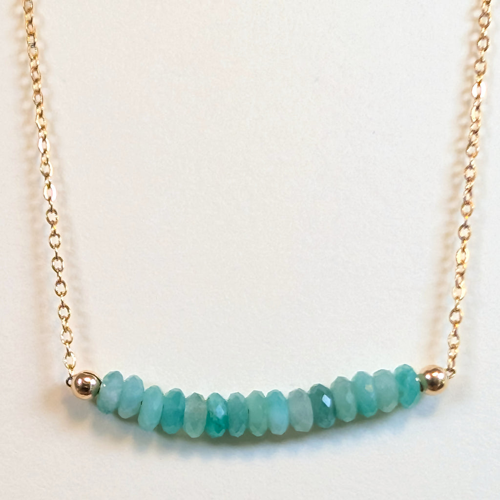 May birthstone necklace with faceted emerald beads on a gold chain