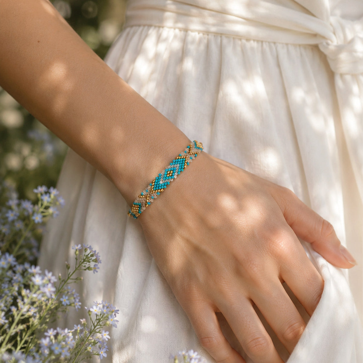Model wearing the Woven Roots Aqua handwoven Miyuki bracelet