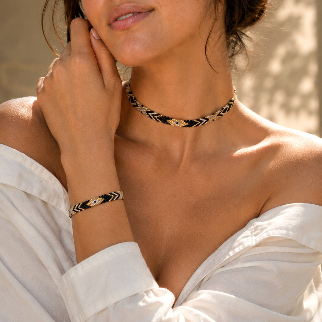 Model wearing the Woven Roots Onyx bracelet with the matching Loom Choker