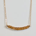 November birthstone necklace with faceted citrine beads on a gold chain