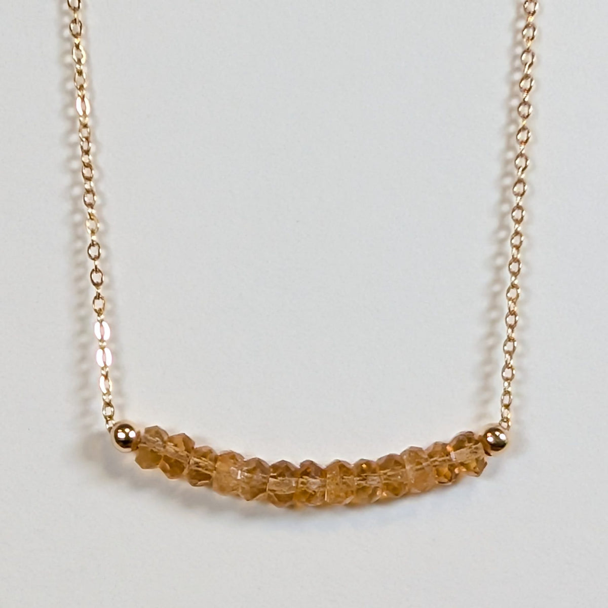 November birthstone necklace with faceted citrine beads on a gold chain