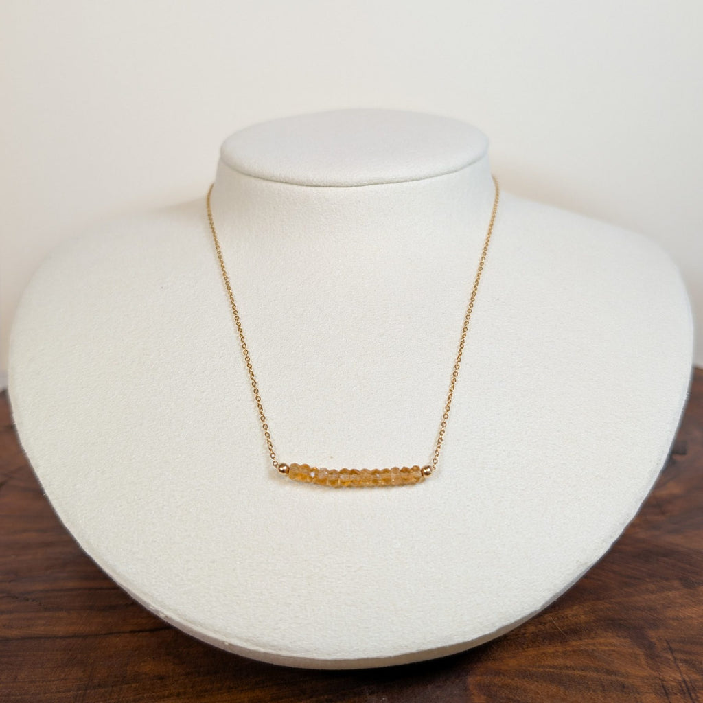 November citrine birthstone necklace on a jewelry display bust