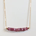 October birthstone necklace with faceted pink tourmaline beads on a gold chain