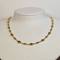 Gold-tone stainless steel choker chain with alternating hearts and stars on a white display bust