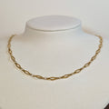 Gold-tone stainless steel choker chain of elongated marquise links on a white display bust