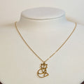 Gold-tone stainless steel necklace with a cut-out origami fox pendant on a white display bust